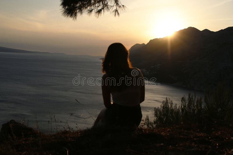 Contemplative landscape with golden light over mountains and water